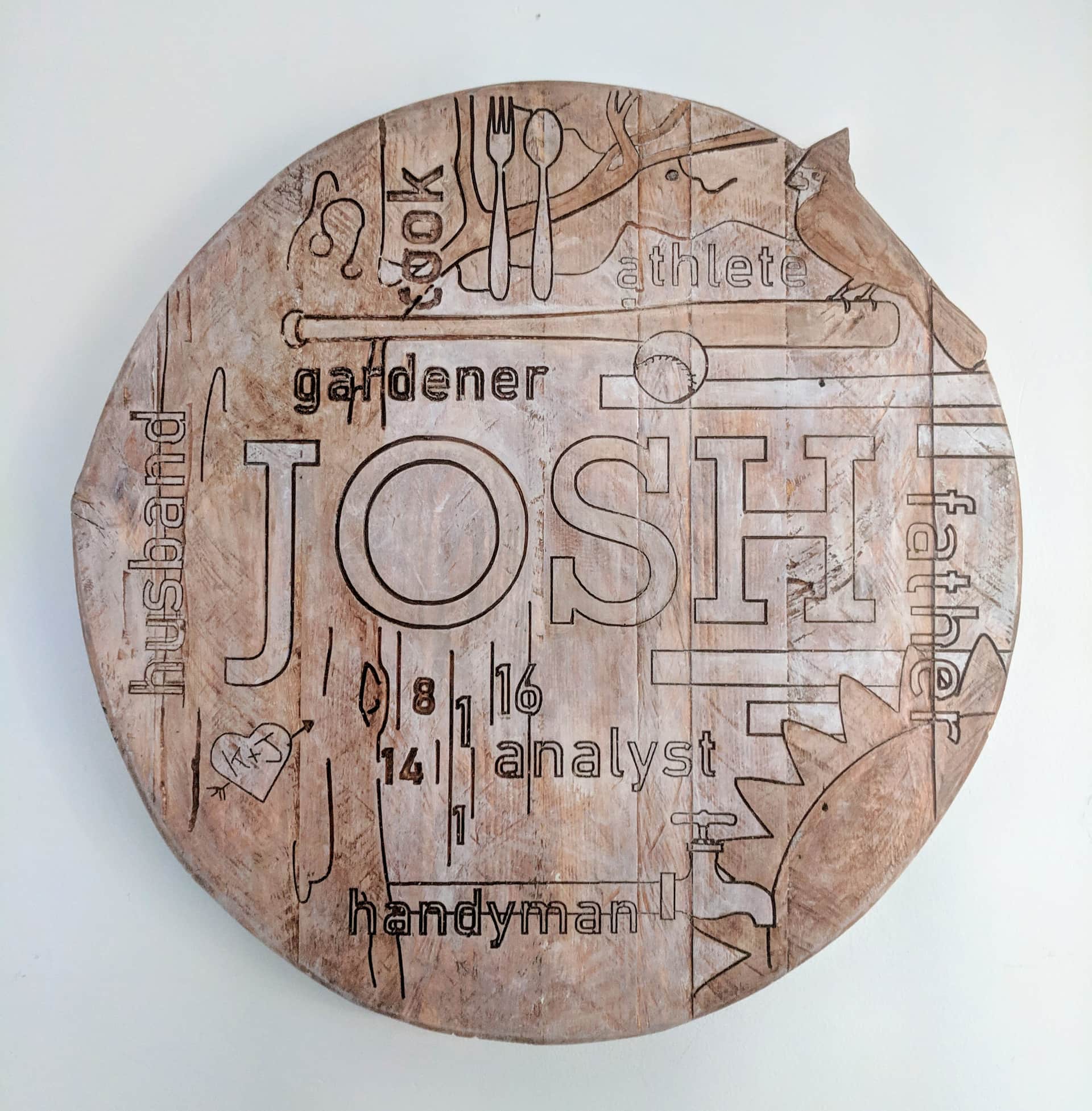 CNC-carved plaque with words and designs from Josh's life carved into it.