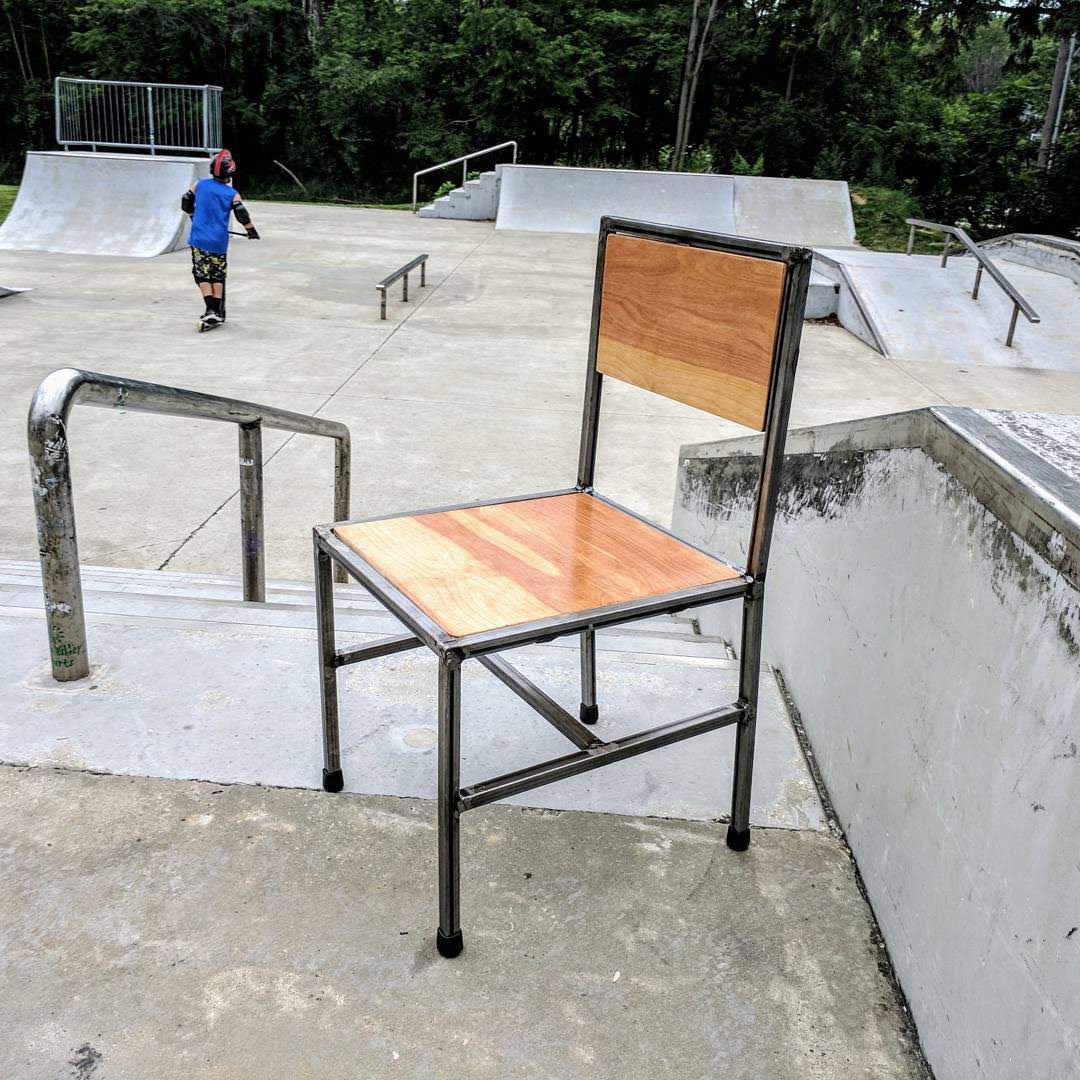 Simple chair with steel square tube frame and plywood surfaces.