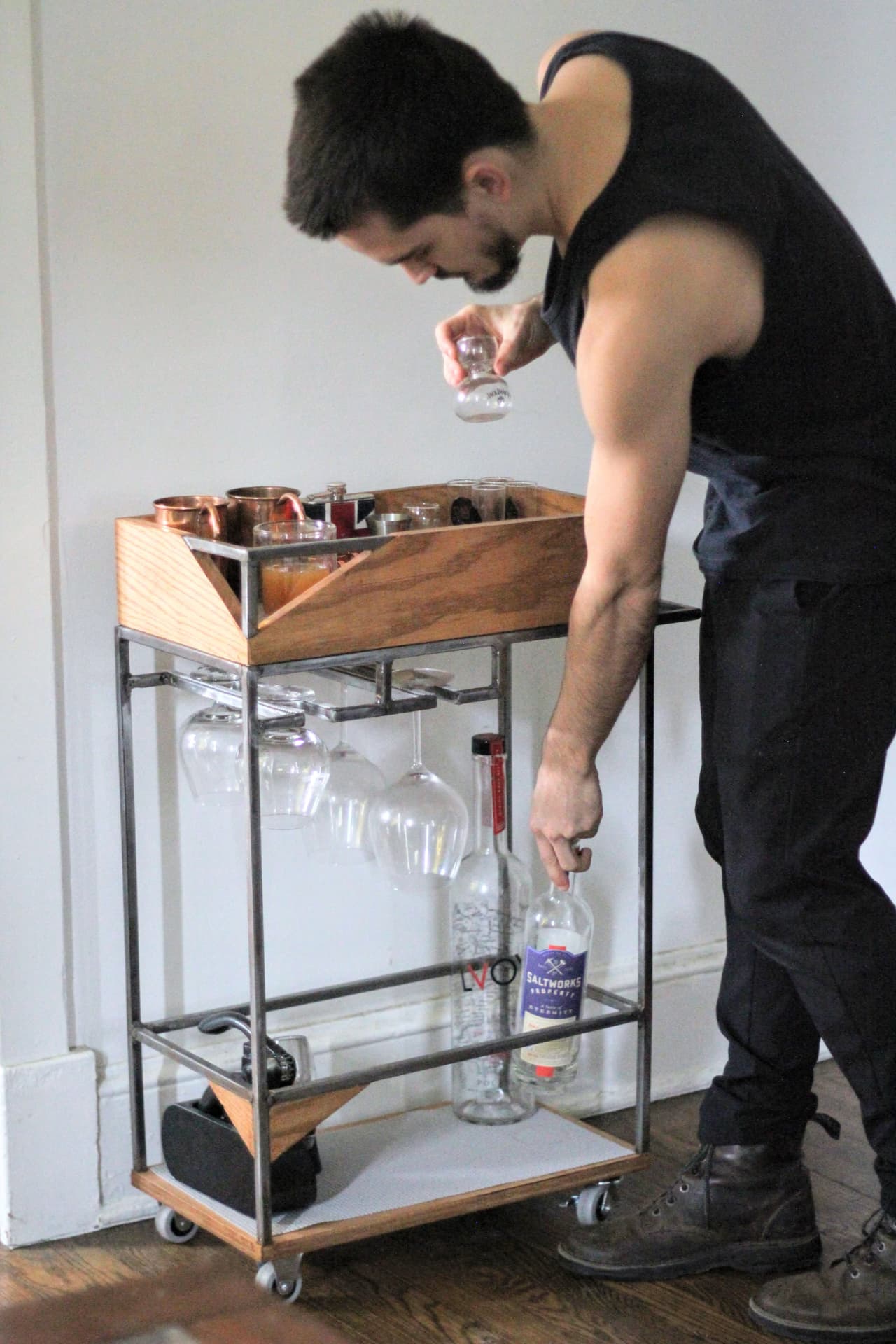 Frank in front of the bar cart he made.